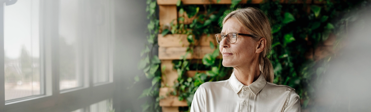 Woman in office looking out of window