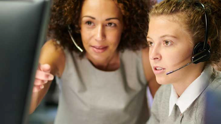 Two women looking looking a computer screen