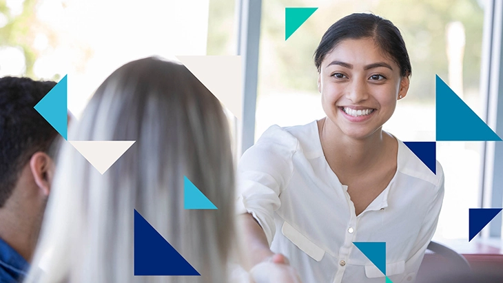 Young woman smiling at colleagues