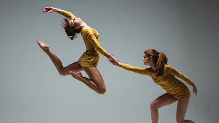 Two women doing acrobatic dance