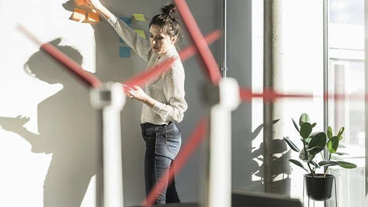 Woman with model wind turbines