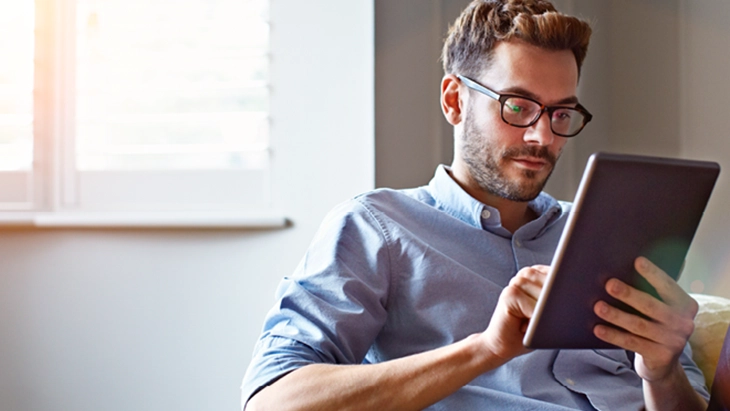 Man with glasses working with tablet