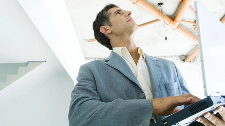 Man holding tablet and looing at ceiling