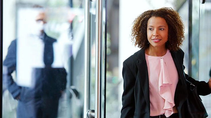 Woman entering office space with worried look